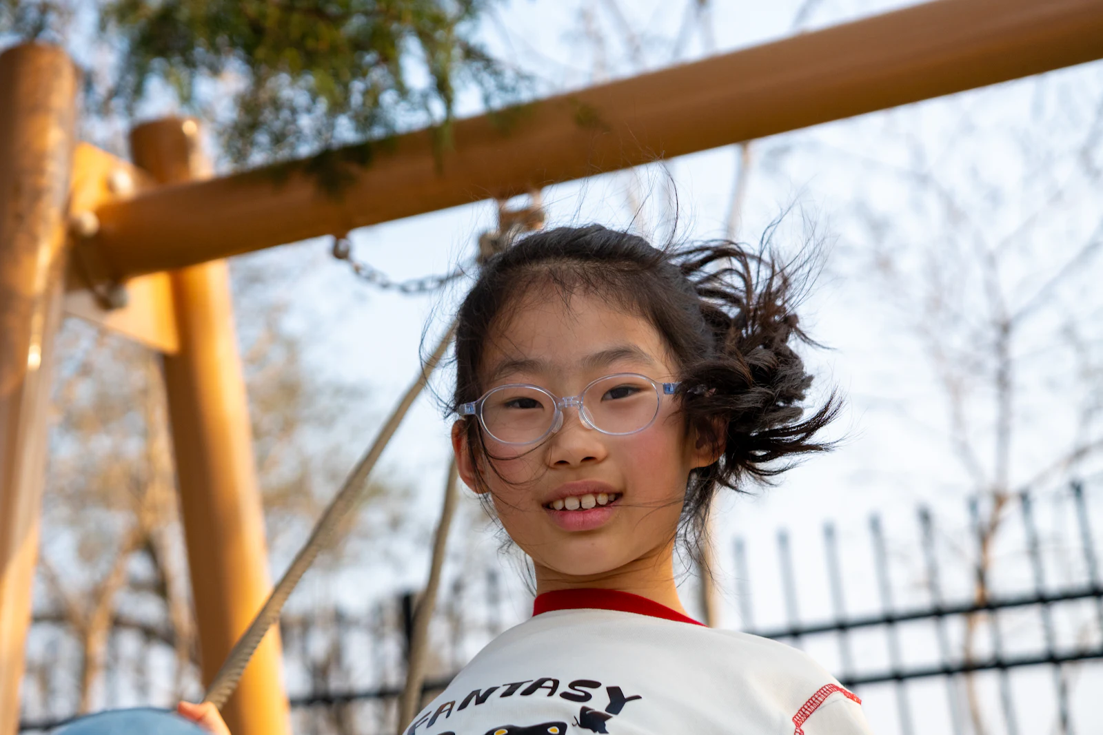 A smiling schoolgirl in glasses, after her vision check
