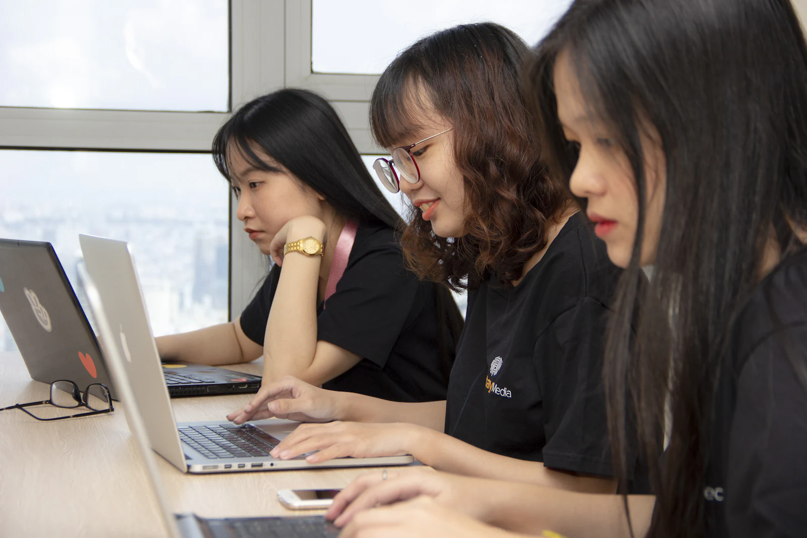 Colleagues working together at their laptops